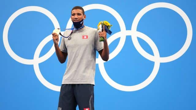 Ahmed Hafnaoui, of Tunisia, poses with his gold medal after winning final of the men's 400-meter freestyle at the 2020 Summer Olympics, Sunday, July 25, 2021, in Tokyo, Japan.