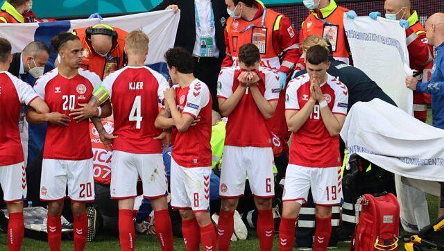 Denmark's players gather as paramedics attend to midfielder Christian Eriksen during the UEFA EURO 2020 Group B match against Finland at the Parken Stadium in Copenhagen. AFP