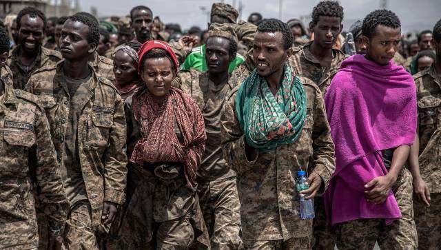 Many of the Ethiopian soldiers bowed their heads and cast their eyes downward. Some had to be carried on stretchers, and others wore bandages freshly stained with blood. Image courtesy: NYT