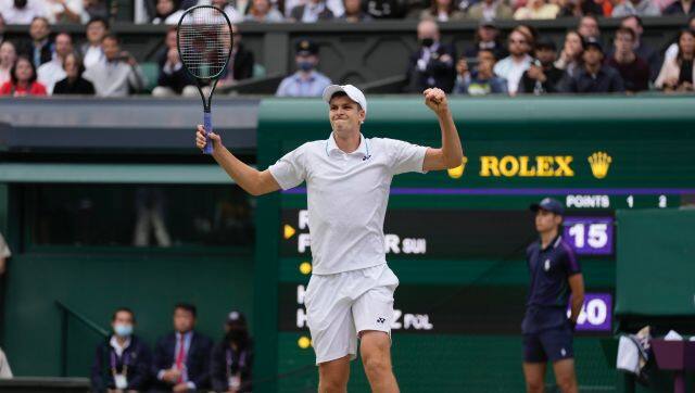 Poland's Hubert Hurkacz celebrates after defeating Switzerland's Roger Federer during the men's singles quarterfinals match on day nine of the Wimbledon Tennis Championships in London, Wednesday, July 7, 2021. (AP Photo/Kirsty Wigglesworth)