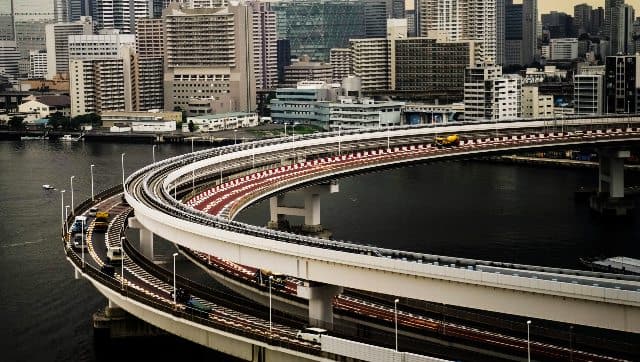 Motorists drive along a spiral ramp onto the Rainbow Bridge in Tokyo. AP 