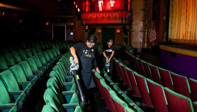 Employees cleaning the El Capitan between showings of “Black Widow.”Credit…Jay L. Clendenin/Los Angeles Times, via Getty Images