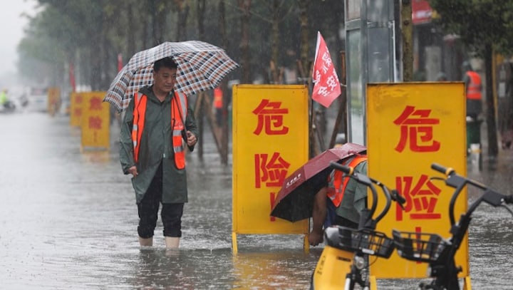 Watch: China's subway passengers trapped in waist-deep waters as deadly floods sweep country