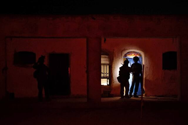 Members of the Afghan Special Forces search a house during a combat mission against Taliban, in Kandahar province. Image courtesy: Danish Siddiqui/Reuters