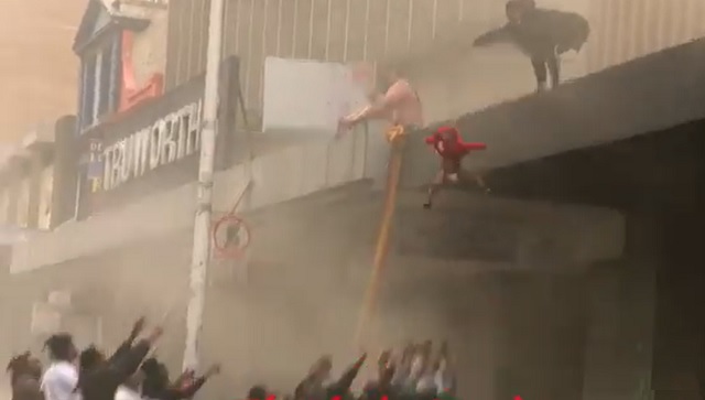 Watch: Mother throws 2-yr-old into arms of passersby after rioters set ablaze Durban building Watch: Mother throws 2-yr-old into arms of passersby after rioters set ablaze Durban building