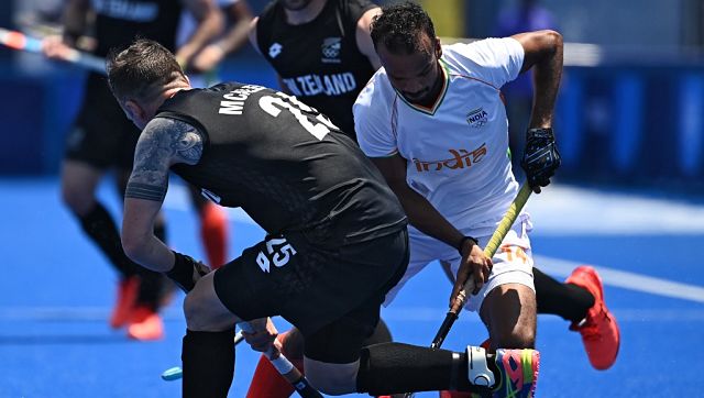 New Zealand’s Shea Mcaleese (L) and India’s Lalit Kumar Upadhyay vie for the ball during their men’s pool A match of the Tokyo 2020 Olympic Games. AFP