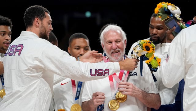 Members of the United States men's basketball team celebrate with coach Greg Popovich after their narrow 87-82 victory over France in the gold medal match. AP