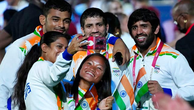 Athletes from India take a selfie during the closing ceremony in the Olympic Stadium at the 2020 Summer Olympics. AP Photo/David Goldman