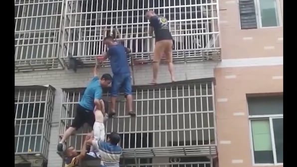 Watch: Six civilians form human chain to rescue kids trapped inside burning building in China