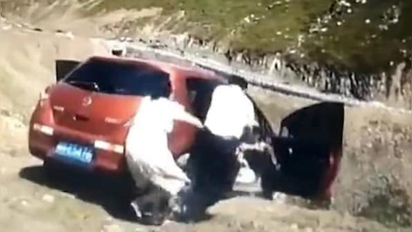 Family jumps out of car as it rolls down a cliff in China's Duku Highway, video goes viral