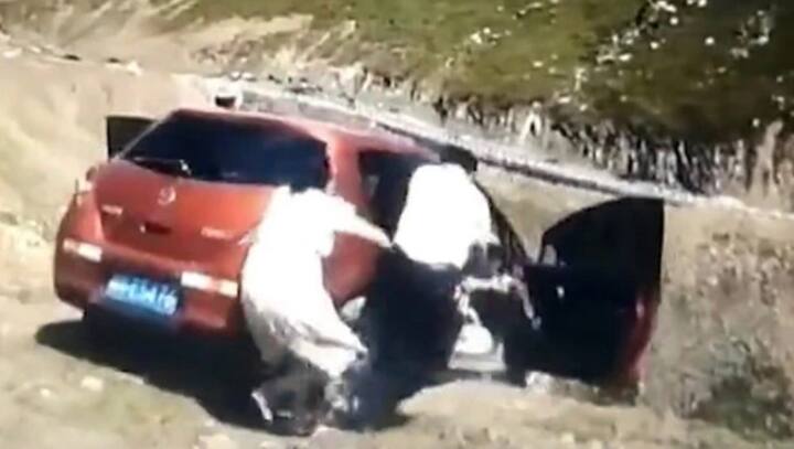 Family jumps out of car as it rolls down a cliff in China's Duku Highway, video goes viral