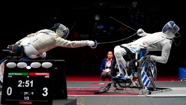 France’s Maxime Valket (left) and Greece’s Panagiotis Triantafyllou compete for a bronze medal in men’s sabre individual category B at the Tokyo 2020 Paralympic Games. AP Photo