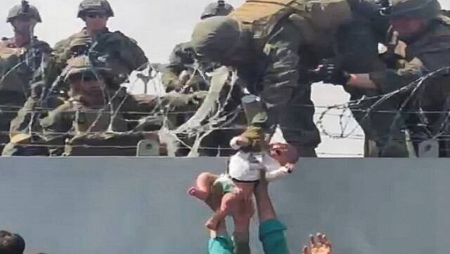 In a heart-rending video that surfaced on Friday, a crying baby was seen being handed over a barbed-wire fence to US Marine troops at the Kabul airport. The US Department of Defence later confirmed the baby had been reunited with its father and “is safe at the airport”. Image courtesy: Omar Haidar via AFP