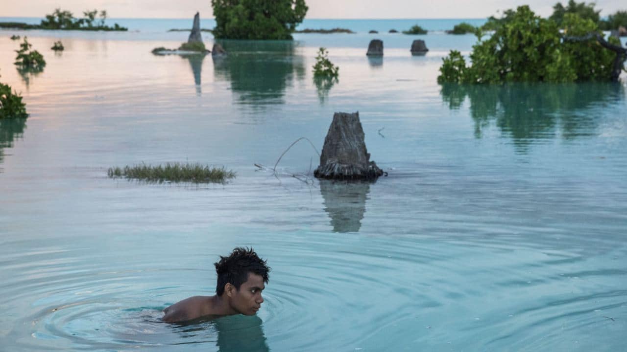 On 26 October 2014, Peia Kararaua, 16, swims in the flooded area of Aberao village in Kiribati. Kiribati is one of the countries most affected by sea level rise. During high tides many villages become inundated making large parts of them uninhabitable.....On 22 March 2017, a UNICEF report projects that some 600 million children – or 1 in 4 children worldwide – will be living in areas where water demand far outstrips supply by 2040. Climate change is one of the key drivers of water stress, which occurs when more than 80 per cent of the water available for agriculture, industry and domestic use is withdrawn annually. According to the report “Thirsting for a Future”, warmer temperatures, rising sea levels, increased floods, droughts and melting ice affect the quality and availability of water. Population growth, increased water consumption, and an even higher demand for water largely due to industrialization, are also draining water resources worldwide, forcing children to use unsafe water, which exposes them to potentially deadly diseases like cholera and diahrroea. The poorest and most vulnerable children will be most impacted, as millions of them already live in areas with low access to safe water and sanitation. The impact of climate change on water sources is not inevitable, the report says, citing a series of recommendations that can help curb its effect on the lives of children.