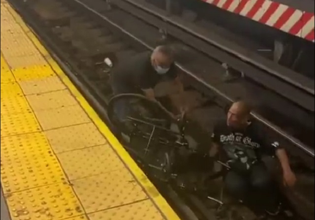 Not all heroes wear capes: Man rescues wheelchair-bound commuter who fell on tracks, minutes before train arrives Not all heroes wear capes: Man rescues wheelchair-bound commuter who fell on tracks, minutes before train arrives