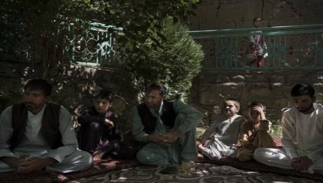 Painda Mohammed, left, sits with family members at their house's yard near Kabul on Friday, 17 September, 2021. AP