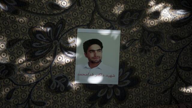A portrait of Fida Mohammad, a 24-year-old dentist, who died after falling from a departing U.S. Air Force C-17 on Aug. 16, hangs in his family house in Kabul, Afghanistan, Friday, 17 September 17, 2021. AFP