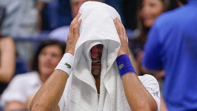 Novak Djokovic, of Serbia, cries as he sits on his bench during a changeover in the third set of the men's singles final against Daniil Medvedev, of Russia, of the US Open tennis championships, Sunday, Sept. 12, 2021, in New York. (AP Photo/John Minchillo)