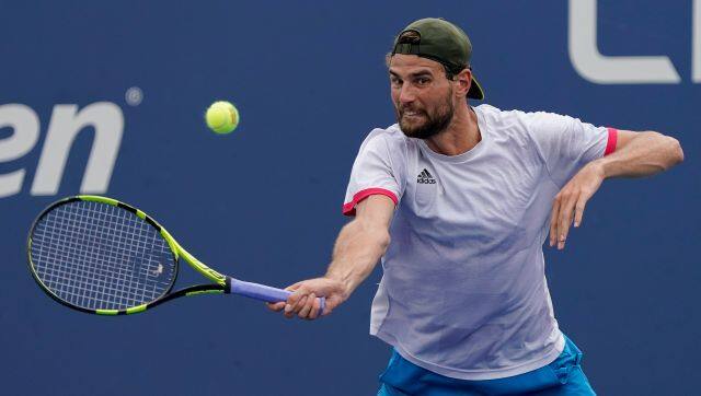 Maxime Cressy, of the United States, returns a shot to Pablo Carreno Busta, of Spain, during the first round of the US Open tennis championships, Tuesday, Aug. 31, 2021, in New York. (AP Photo/Seth Wenig)