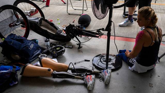 Oksana Masters, from USA, sits next to her bike after wining at women’s H4-5 Time Trial at the Fuji International Speedway at the Tokyo 2020 Paralympic Games, Tuesday, Aug. 31, 2021, in Tokyo, Japan. (AP Photo/Emilio Morenatti)