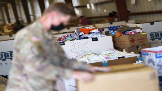 A soldier sifts through donations at Fort Bliss' Doña Ana Village. AP