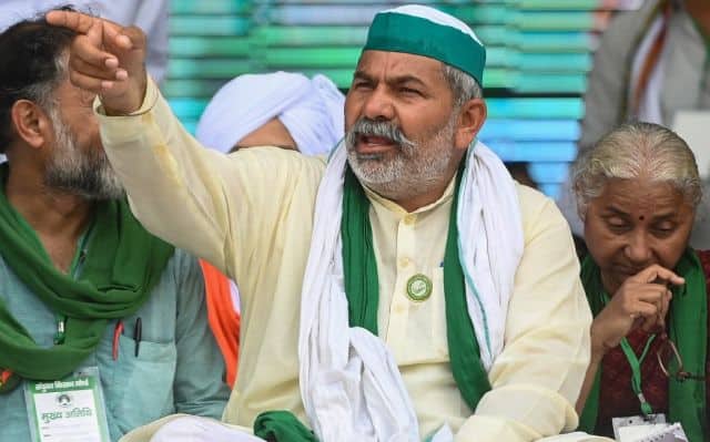 Bharatiya Kisan Union leader Rakesh Tikait gestures as he arrives to attend the mahapanchayat in Muzaffarnagar. AFP