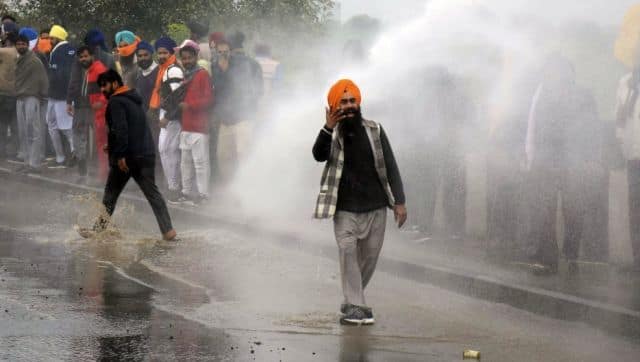 File photo of Police blocking a road and using a water cannon to disperse farmers marching to New Delhi to protest against the central government's farm laws, on the outskirts of Ambala. AFP