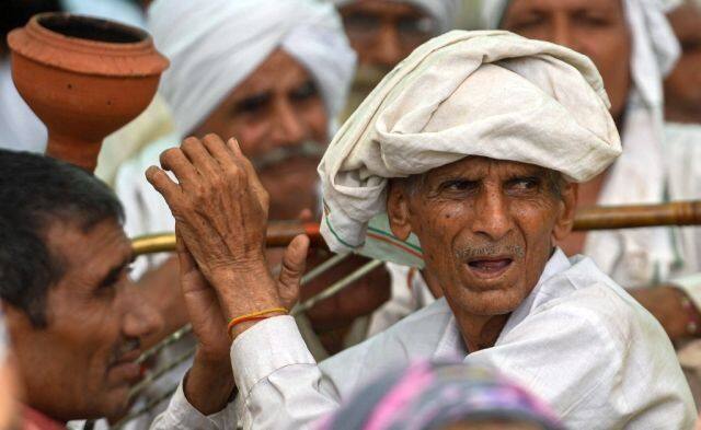 The farmers carrying flags of different organisations and wearing different coloured caps converged for the mahapanchayat, the biggest ever in the last nine months. AFP