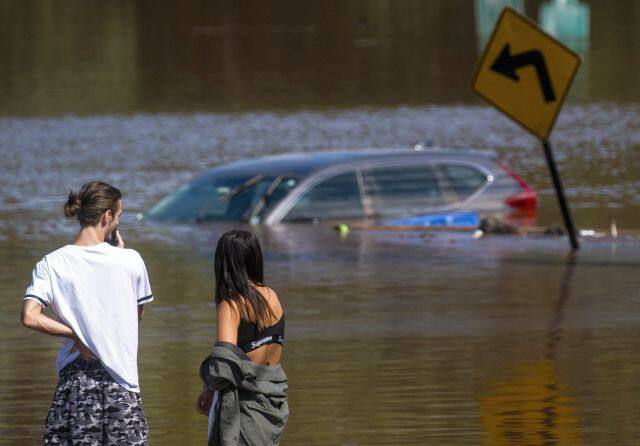 Flooding closed major roads across New York boroughs including Manhattan, The Bronx and Queens, submerging cars and forcing the fire department to rescue hundreds of people. AP