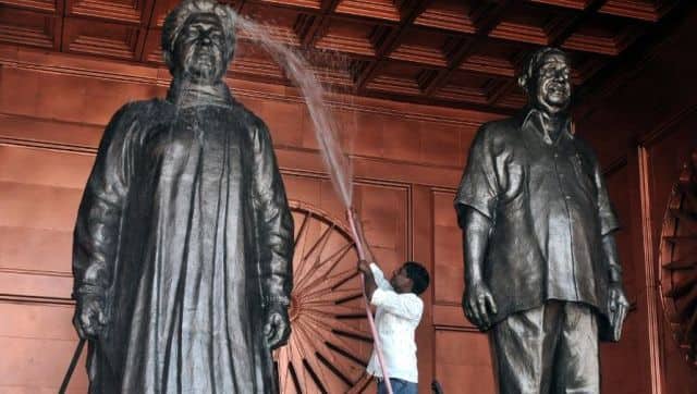 A labourer washes a statue of the Bahujan Samaj Party leader Mayawati and BSP founder Kashi Ram in Lucknow. AFP