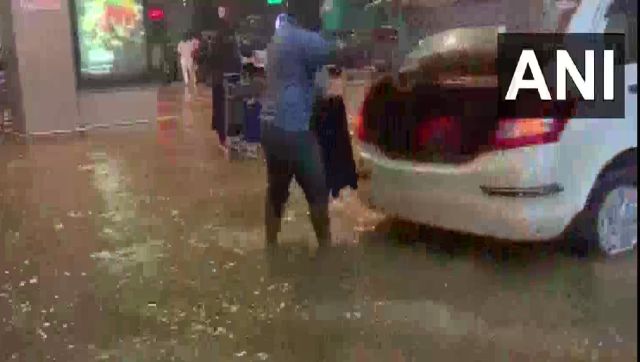 Heavy rain floods Bengaluru airport; flyers take tractor rides to catch their flights Heavy rain floods Bengaluru airport; flyers take tractor rides to catch their flights