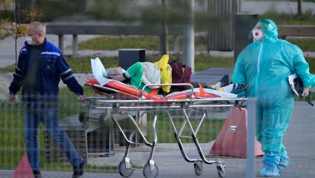Medical workers carry a patient suspected of having coronavirus on a stretcher at a hospital in Kommunarka, outside Moscow, Russia on 11 October. AP 