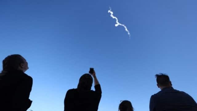 People watch as Blue Origin’s New Shepard flies toward space. AFP 