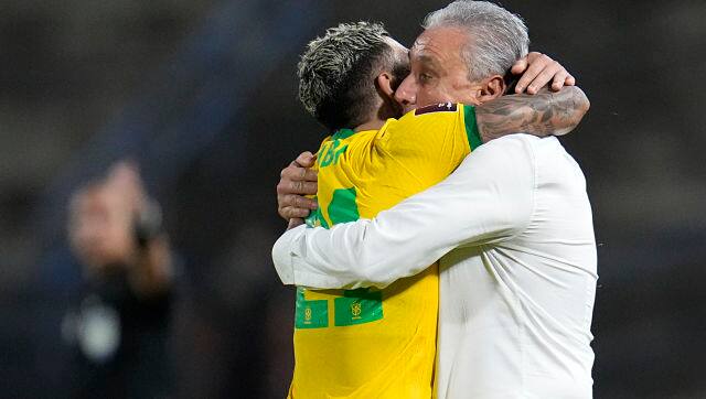 Brazil’s Gabriel Barbosa, left, celebrates with Brazil’s coach Tite after scoring his side’s second goal from the penalty spot against Venezuela. AP