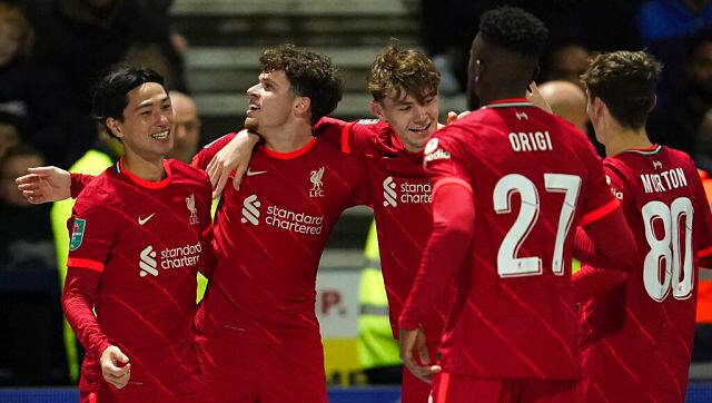 Liverpool's Takumi Minamino celebrates with teammates after scoring his side's opening goal against Preston North End. AP
