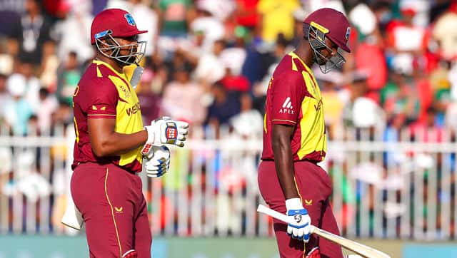 West Indies’ captain Kieron Pollard (left) and teammate Jason Holder walk from the field at the end of their innings during the Twenty20 World Cup match against Bangladesh in Sharjah. AP Photo