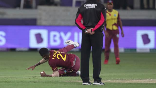 Left-arm spinner Akeal Hossain collects a superb catch off his own bowling to dismiss Liam Livingstone. AP