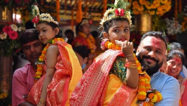 Hindu devotees carry girls dressed as Hindu goddess Durga for the ‘Kumari’ rituals during the Durga Puja festival at Kamakhya Temple in Guwahati on 11 October, 2021. AFP 