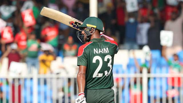 Mohammad Naim waves his bat as he celebrates scoring a fifty. He played a knock of 62 off 52 balls. AP 