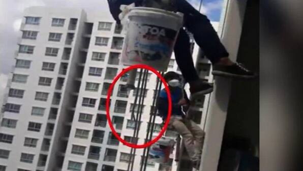 Video: Workers in Thailand left dangling from 26th floor after woman cuts rope