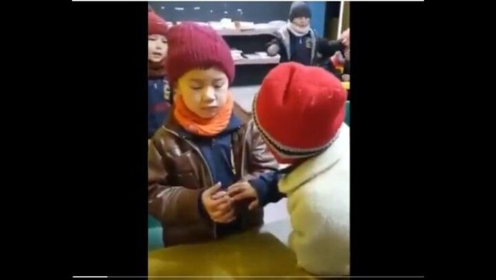 School girl comforts emotional classmate as he misses his home; video wins hearts