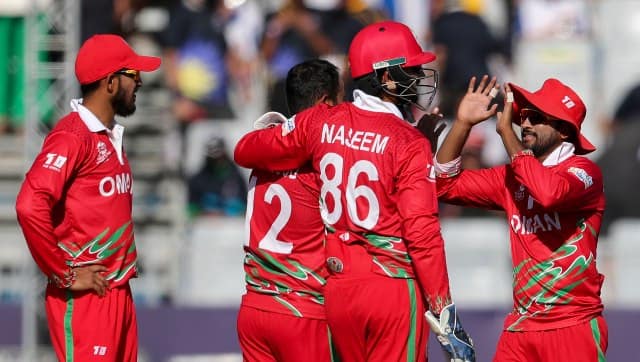 Oman's Zeeshan Maqsood celebrates taking a wicket with his teammates. AP