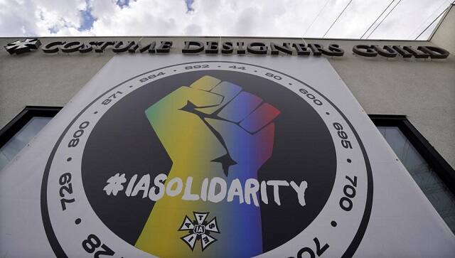 A poster advocating union solidarity hangs from a Costume Designers Guild office building, Monday, Oct. 4, 2021, in Burbank, Calif. The International Alliance of Theatrical Stage Employees (IATSE) overwhelmingly voted to authorize a strike for the first time in its 128-year history. (AP Photo/Chris Pizzello)