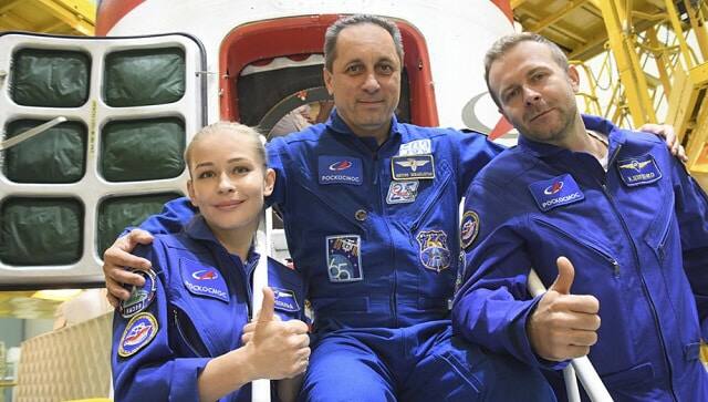 Actress Yulia Peresild, left, director Klim Shipenko’ right, and cosmonaut Anton Shkaplerov, members of the prime crew of Soyuz MS-19 spaceship pose at the Russian launch facility in the Baikonur Cosmodrome, Kazakhstan, Wednesday, 29 Sept, 2021 (Roscosmos Space Agency via AP)