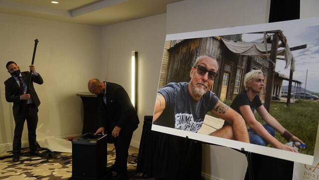 A photo of Serge Svetnoy, left, and Halyna Hutchins is displayed after a news conference with attorney Gary Dordick and his client Serge Svetnoy, chief of lighting on the 