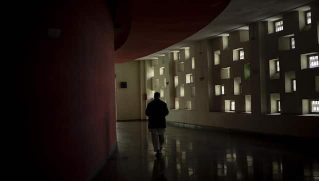 A staff member walks in the hallways of the Ariana Cinema on Thursday, Nov. 4, 2021. The cinema’s staff still show up at work every day hoping they will eventually get paid, despite the Taliban’s orders to stop operating. (AP Photo/Bram Janssen)