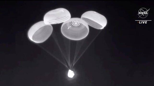 Parachutes are deployed from the SpaceX Dragon capsule as it descends before splashing down into the Gulf of Mexico. The newcomers were scheduled to launch first, but NASA switched the order because of bad weather and an astronaut’s undisclosed medical condition. AP