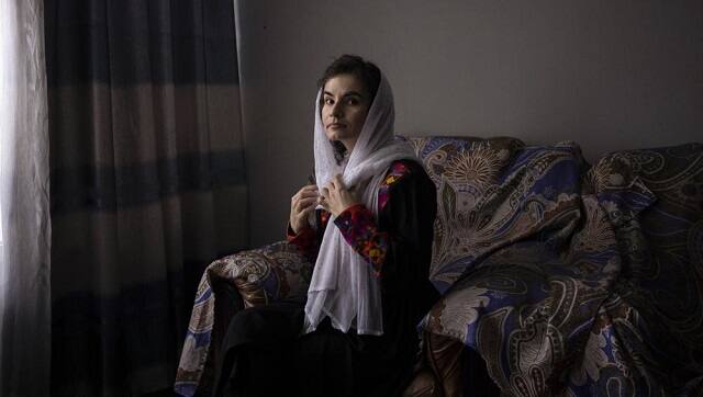 Asita Ferdous sits inside her home in Kabul, Afghanistan on Wednesday, Nov. 10, 2021. She is the director of the Ariana Cinema but is not allowed to enter the cinema as the Taliban ordered female government employees to stay away from their workplaces. (AP Photo/Bram Janssen)