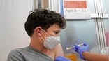 FDA expands Pfizer boosters for children as young as 12 years as omicron surges in US