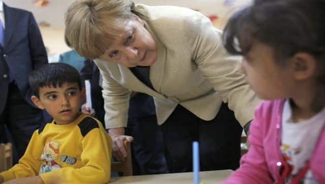 File photo of German Chancellor Angela Merkel talking with refugee children at a preschool, during a visit to a refugee camp on the Turkish-Syrian border in Gaziantep. AFP